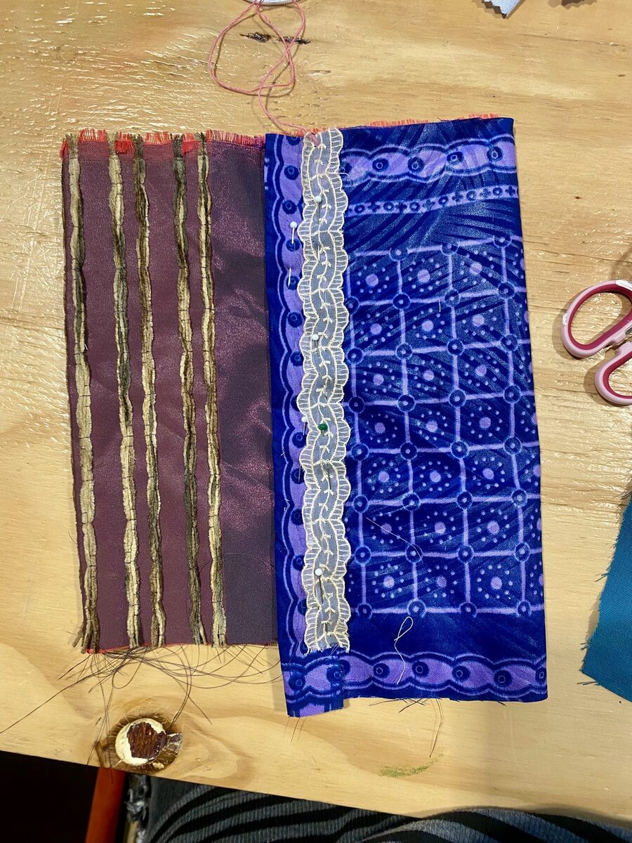 Purple patterned fabric pocket with couched gold threads