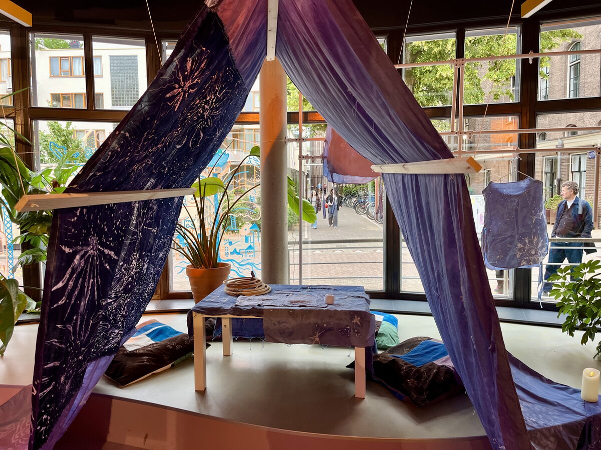 The batik tent installation with table and cushions inside